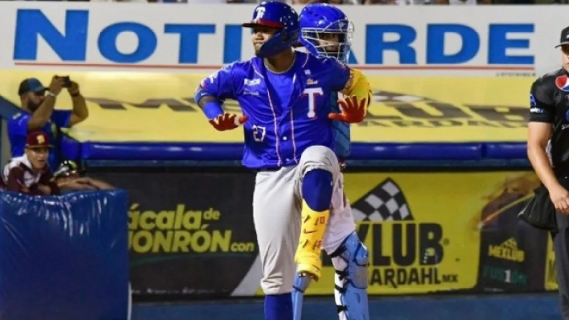 Ronald Acuna Jr. of Tiburones de la Guaira celebrates after scoring a home  run in the third inning against Leones de Caracas, during a Venezuelan  League baseball gamein Caracas, Venezuela, Tuesday, Jan.